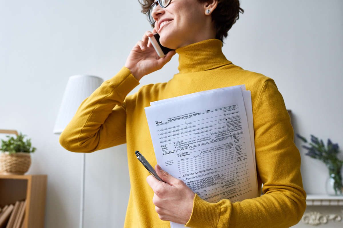 Professional woman reviewing financial paperwork at a desk