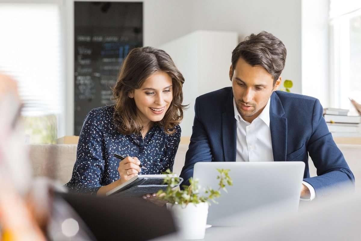 Tax consultation with a client reviewing documents and a laptop